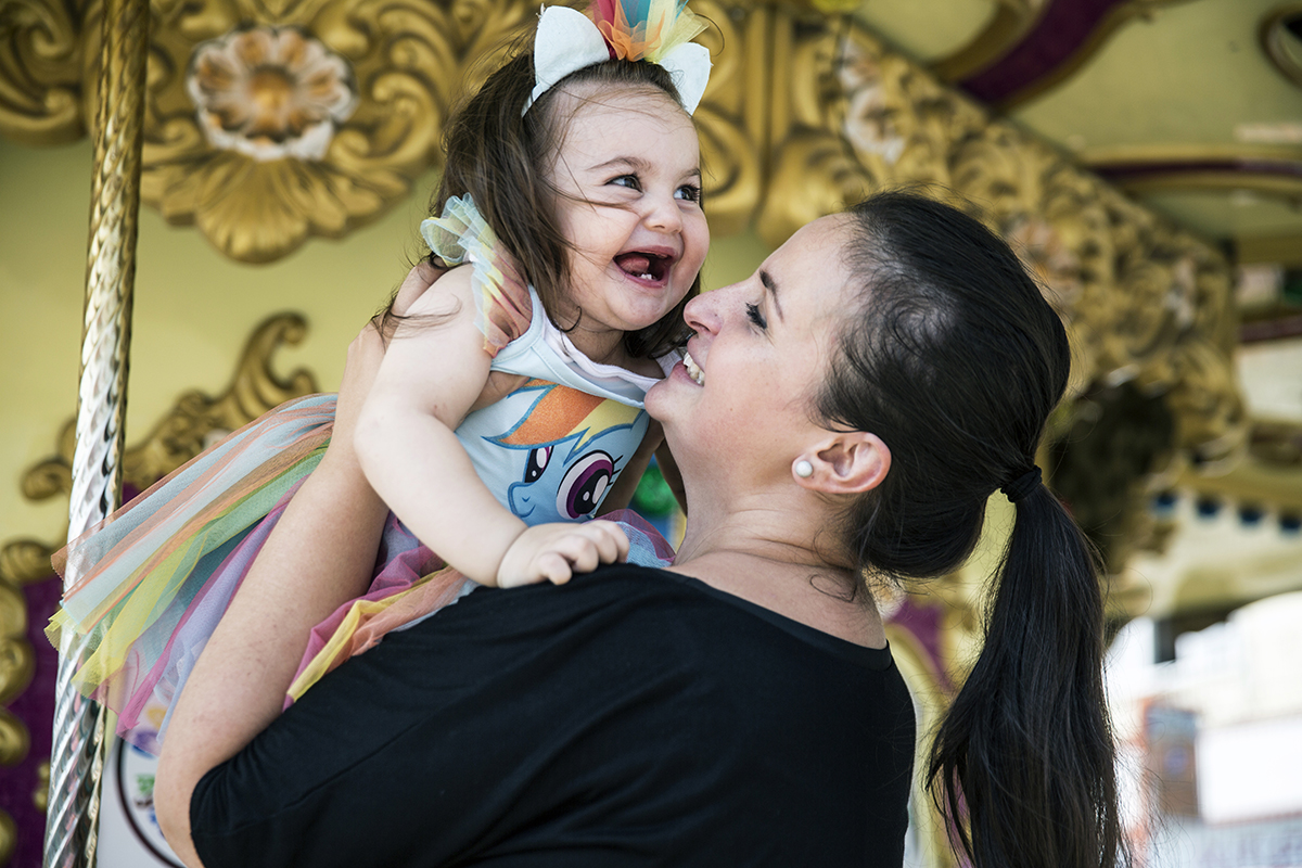 #235 —Maltepe - 
Sersu Kara plays with her 17 month-old daughter Zeynep in the theme park.
